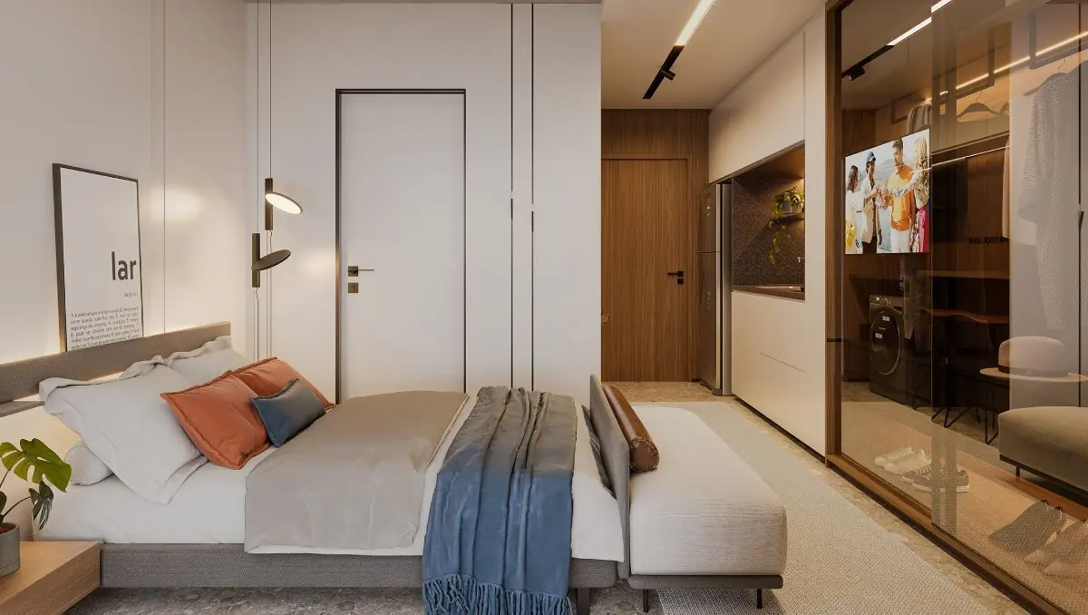 O decorado do studio de 25 m²: a cama, o armário e a bancada num ambiente só.